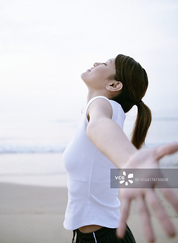 在海滩上深呼吸的日本女人图片素材