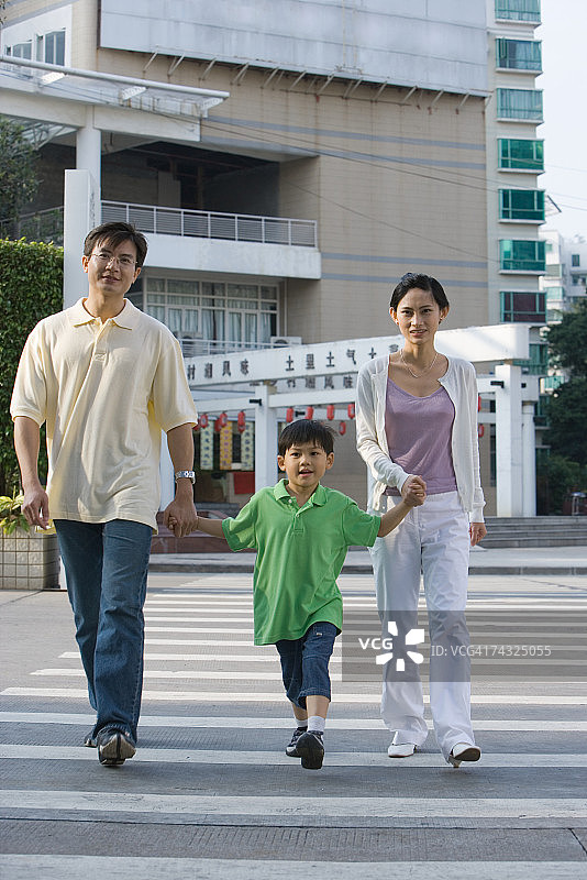 一家人手牵着手过人行横道图片素材