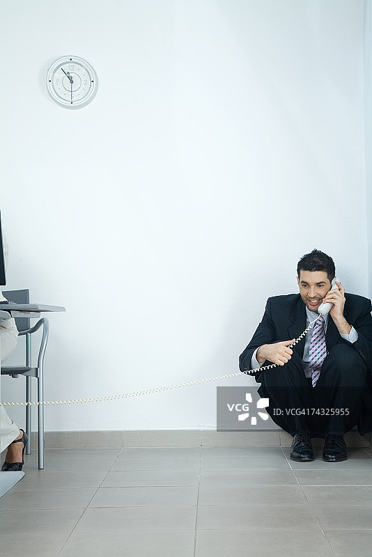 坐在角落里打电话的商人图片素材