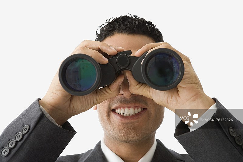 用双筒望远镜观察的西班牙裔商人图片素材