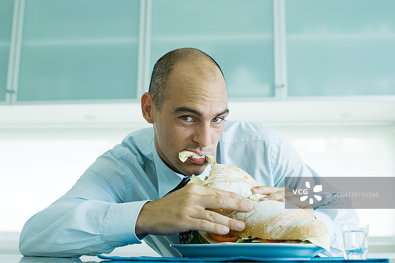 男人咬着大三明治图片素材