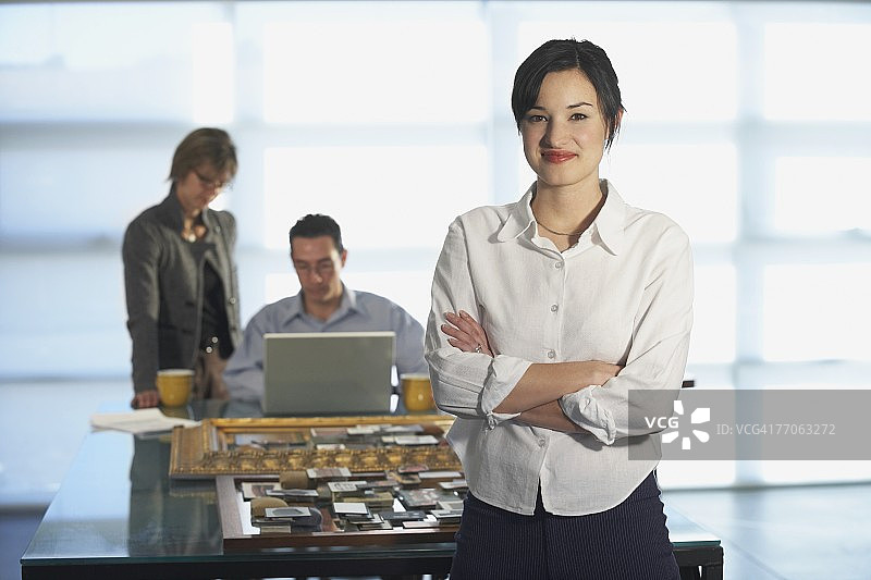 女商人与两位同事在背景中的 портрет图片素材