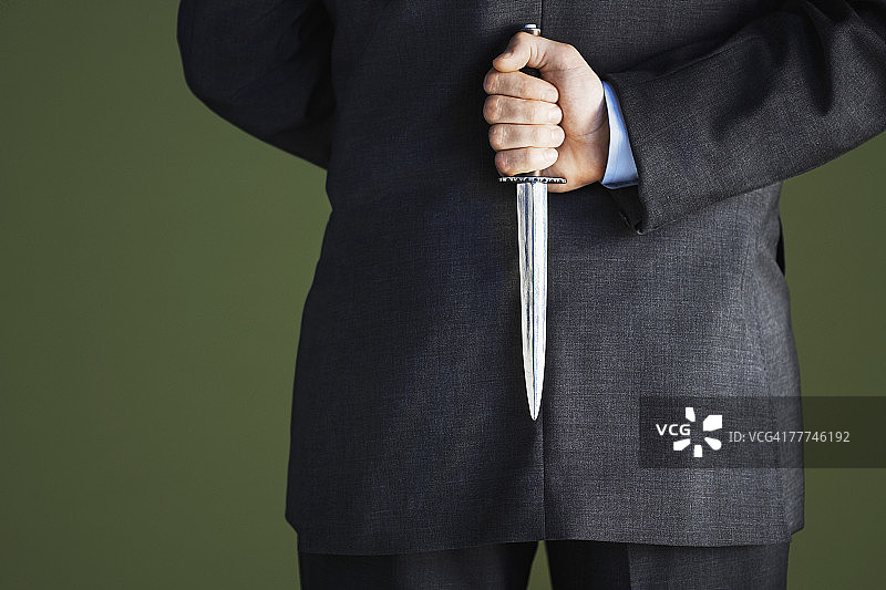 商人背后藏刀图片素材