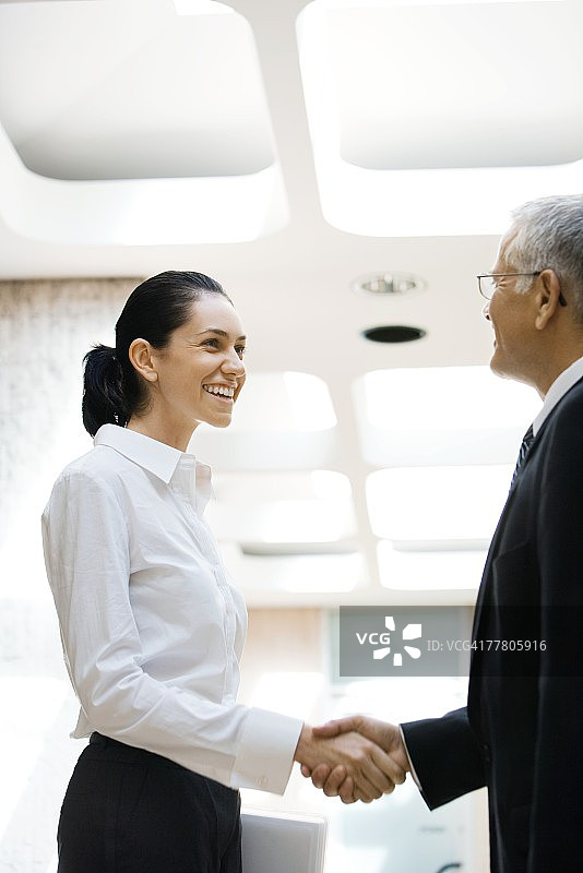 中年商人与年轻女商人握手图片素材