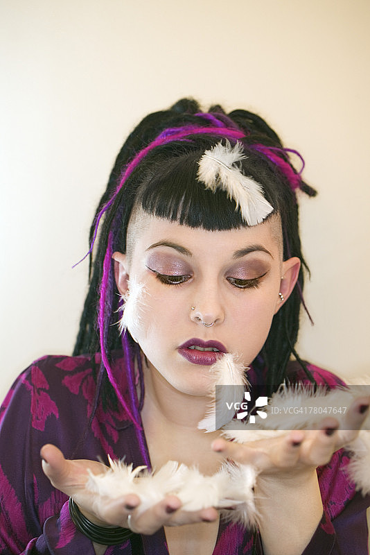 女人洒落白色羽毛图片素材