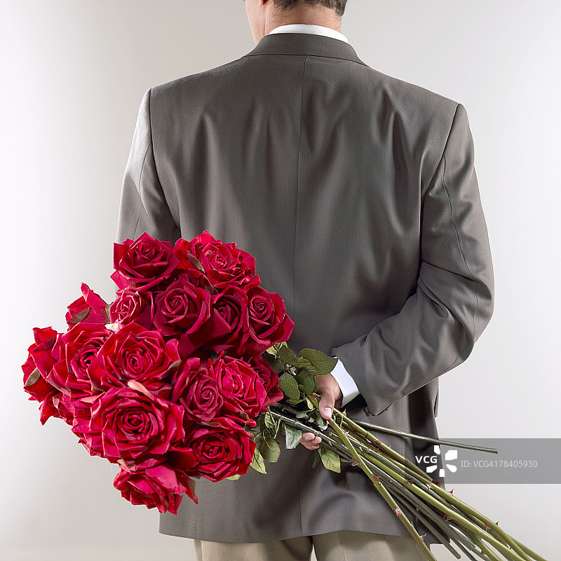 手持红玫瑰的男人图片素材