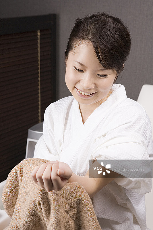 年轻女人用毛巾擦手图片素材