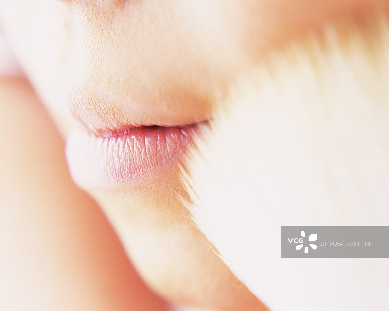 女人用刷子涂抹蜜粉，焦点差异图片素材