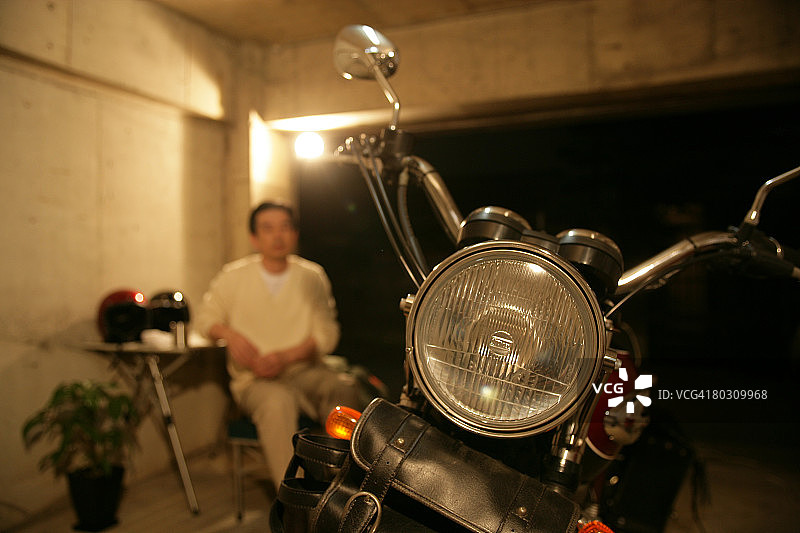 中年男人看摩托车图片素材