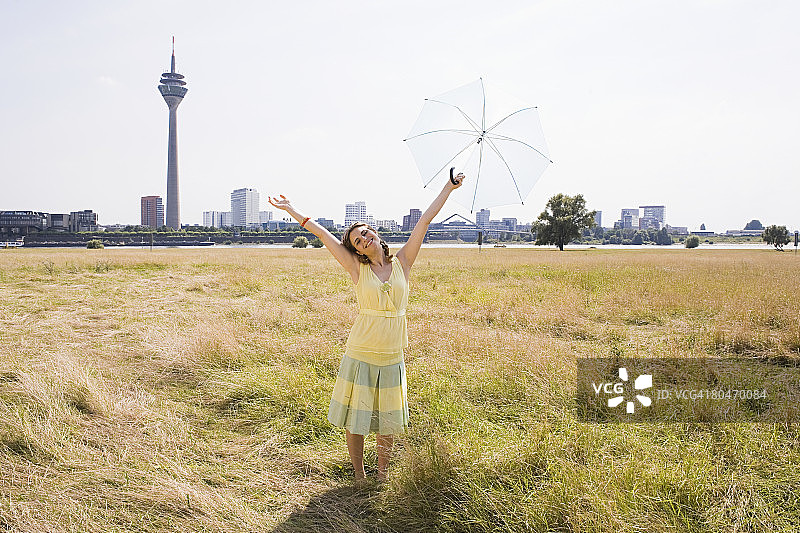 在田野里打着伞的女人图片素材