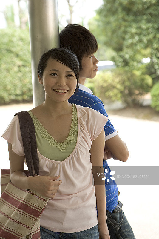 两名年轻人倚靠在柱子上图片素材