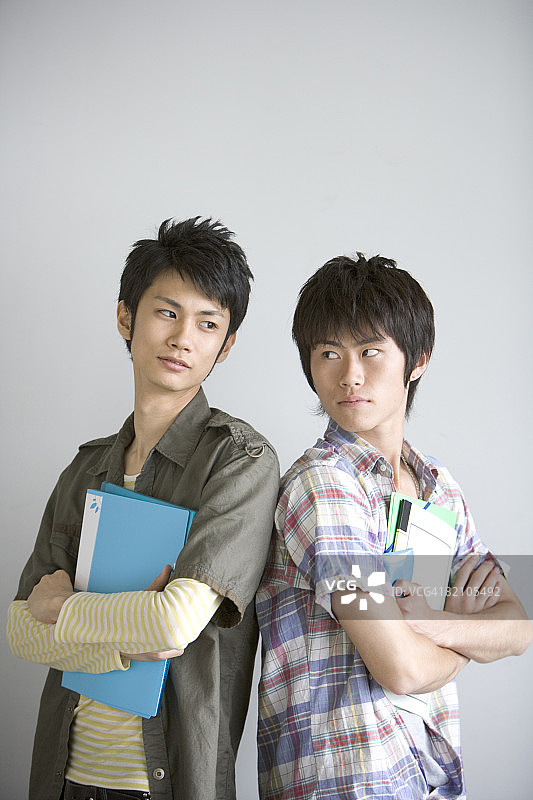 两名男学生背靠背站立图片素材