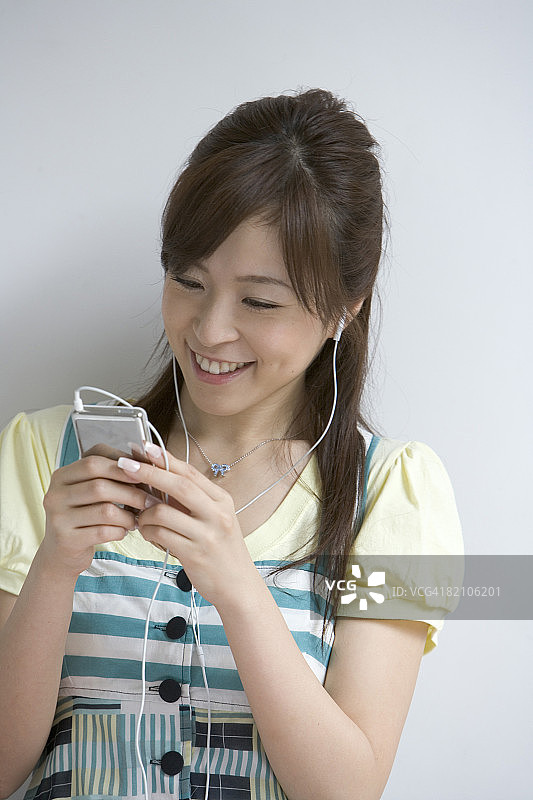 正在听音乐的年轻女人，特写图片素材
