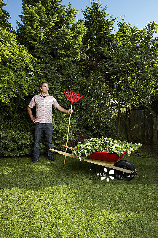 男子拿着耙子站立图片素材