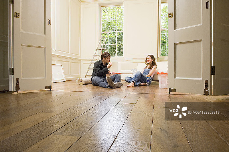 年轻夫妇坐在地板上图片素材