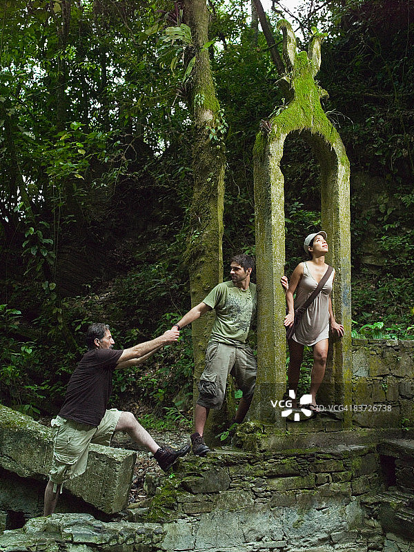 三个徒步旅行者在丛林中探险图片素材