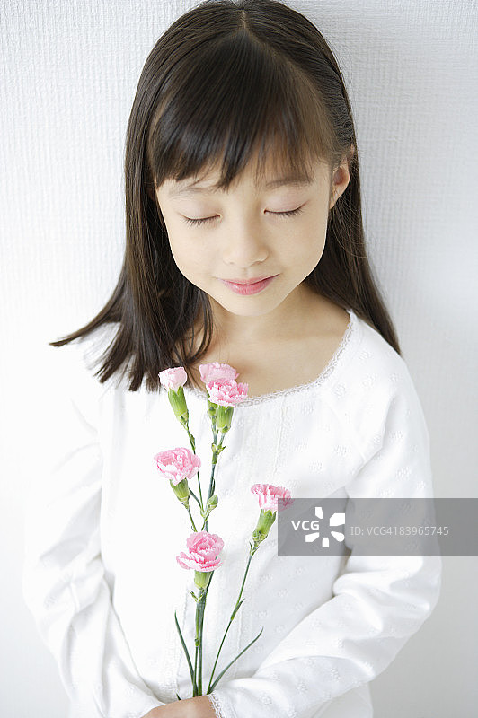 闭着眼睛手捧鲜花的女孩图片素材