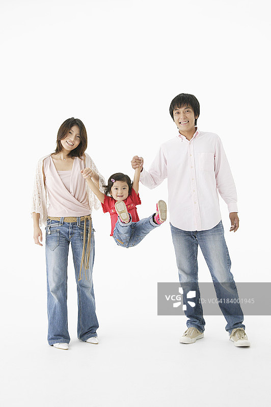 父母举起女儿，影棚拍摄图片素材