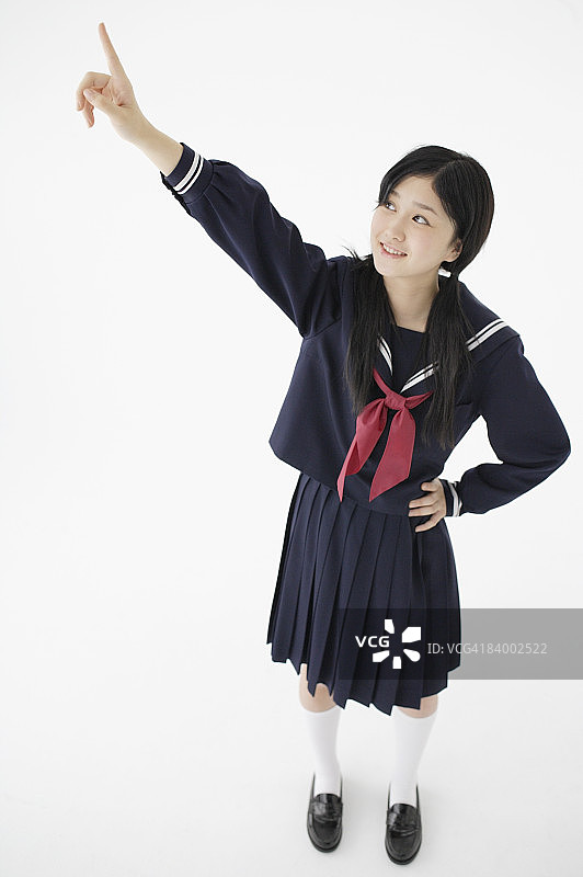 指向上方的女学生肖像，工作室拍摄图片素材