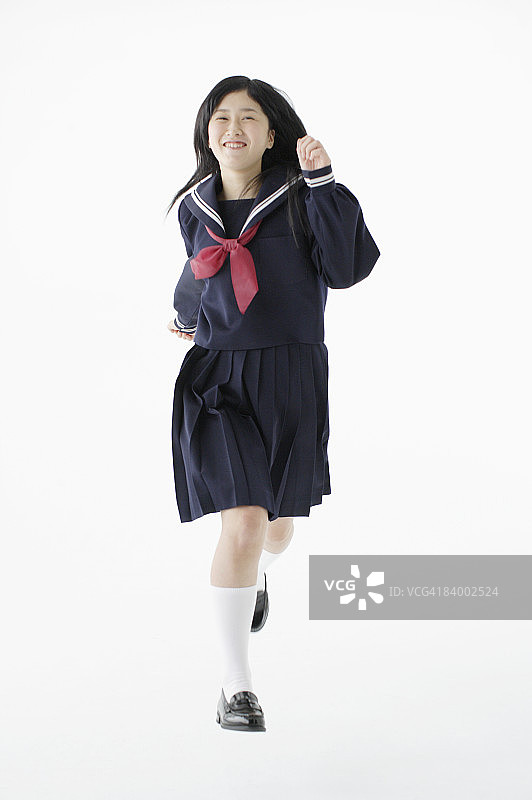 跑步姿势的女学生，工作室拍摄图片素材