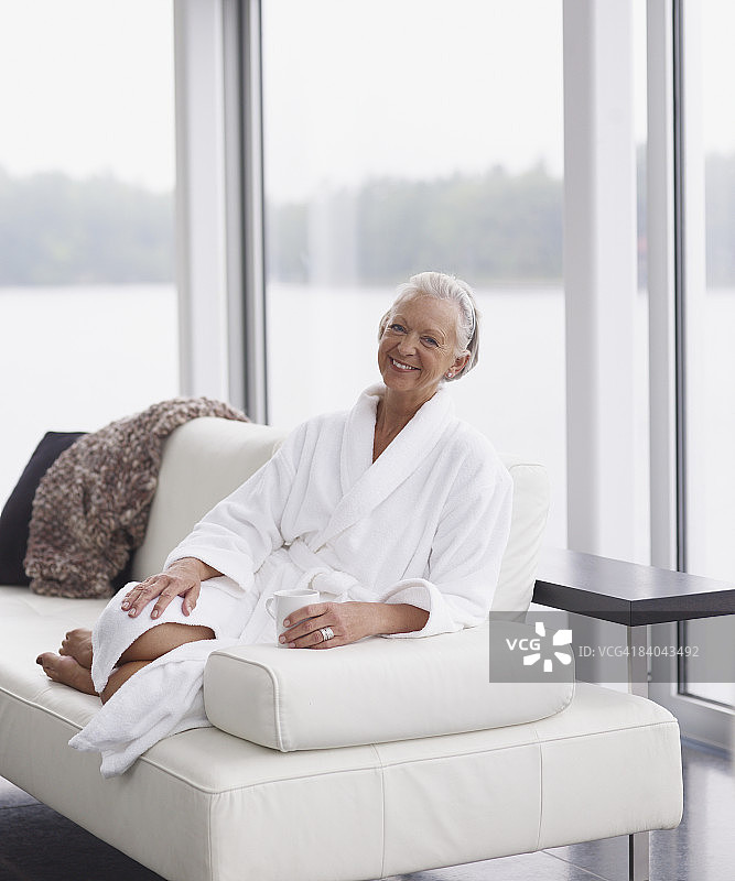 女人穿着浴袍在沙发上放松图片素材