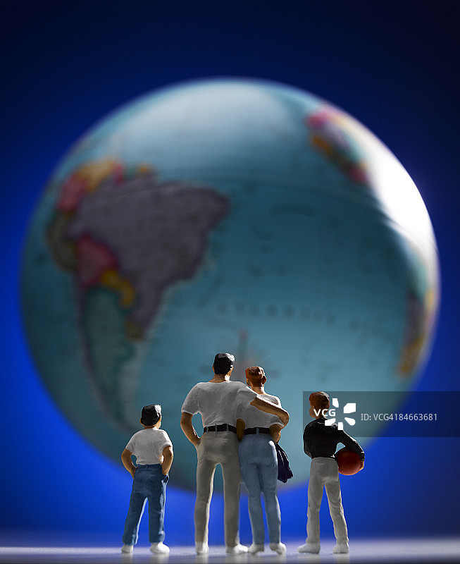 凝视着世界地球仪的家庭模型图片素材