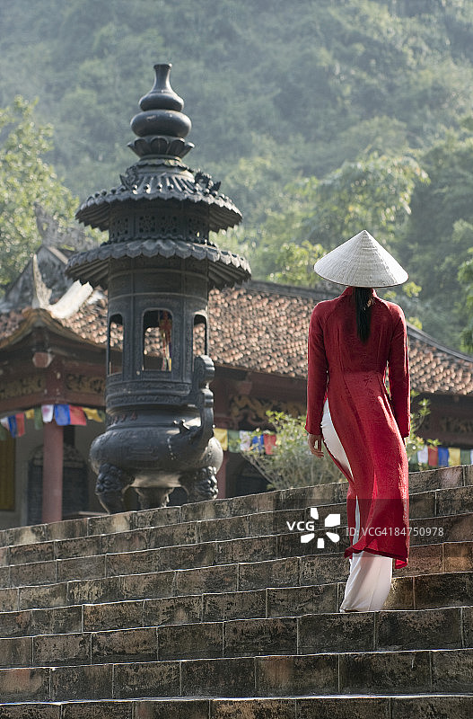 身穿传统服饰站在寺庙台阶上的女人图片素材