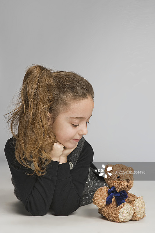 女孩看着泰迪熊图片素材