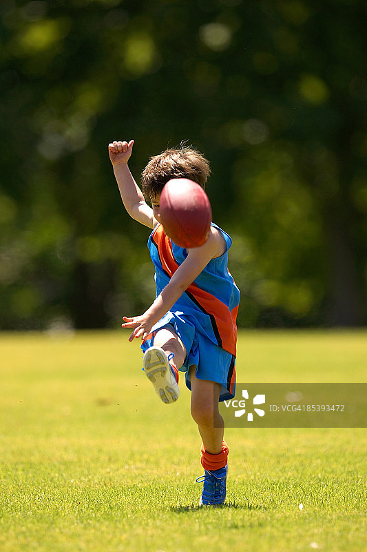 年轻球员向着镜头踢球图片素材