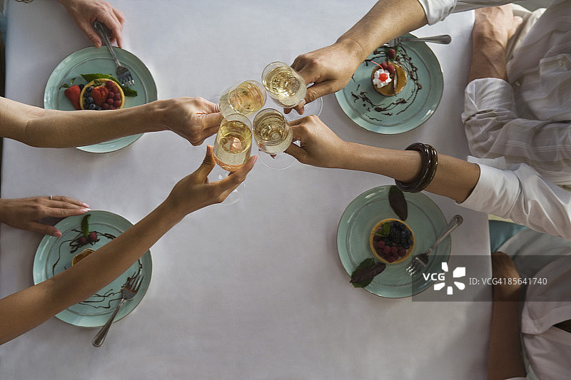朋友们在甜点前举杯庆祝图片素材