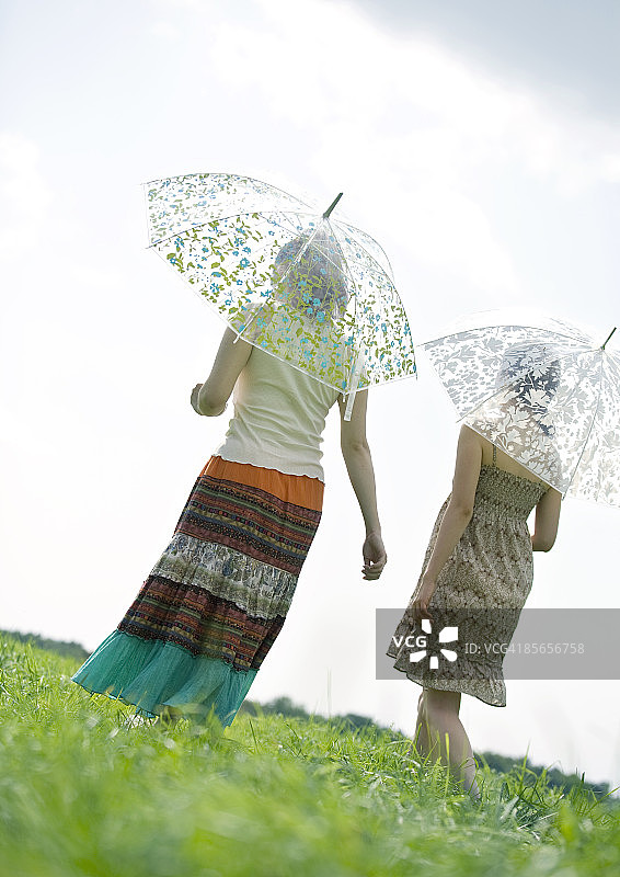 年轻女性撑伞散步图片素材