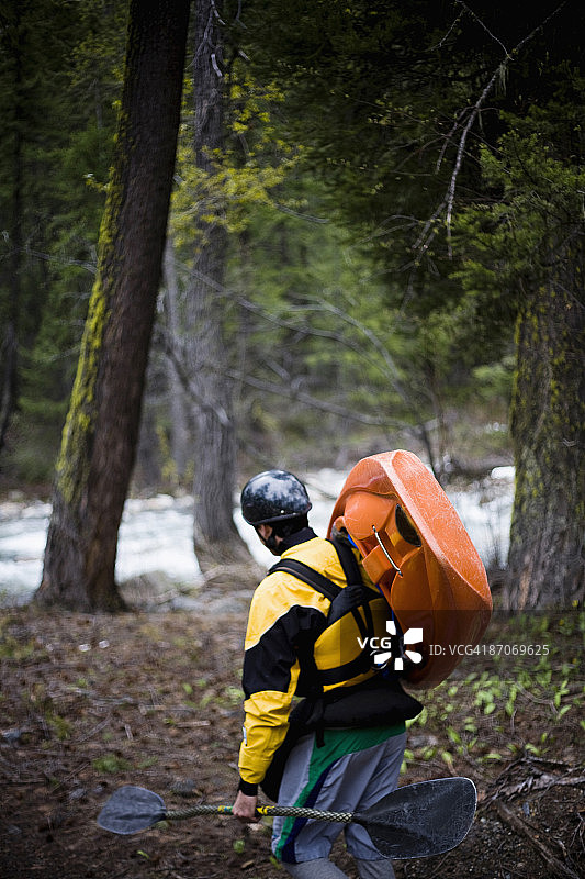 一名男子将皮划艇搬到入水点图片素材
