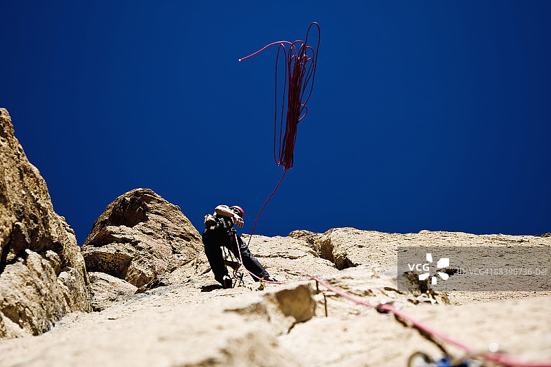 攀岩者在绳降前扔下绳索图片素材