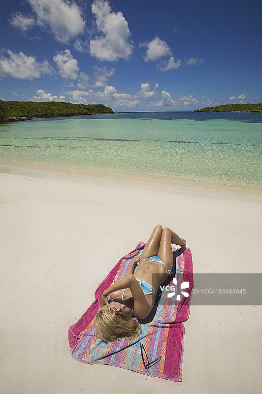 女人在海滩上晒日光浴图片素材