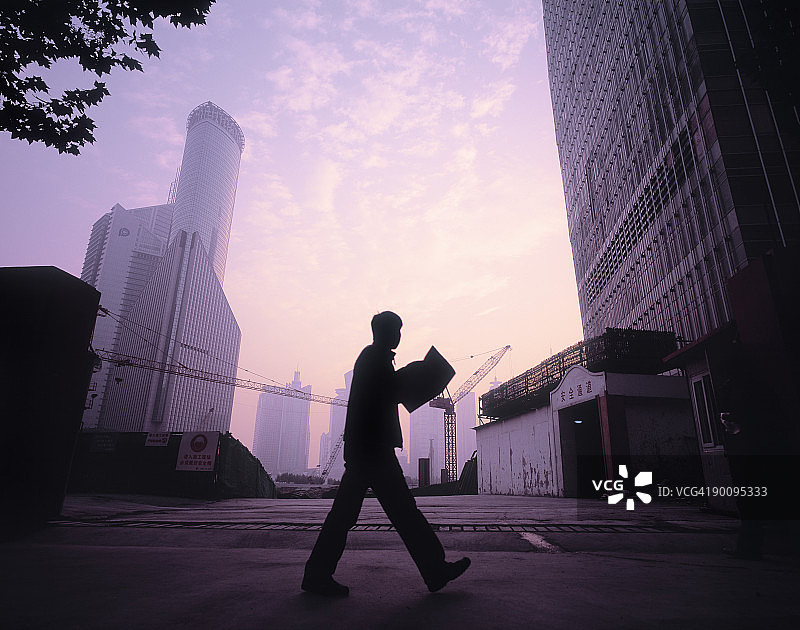 路过建筑工地并阅读报纸的人图片素材