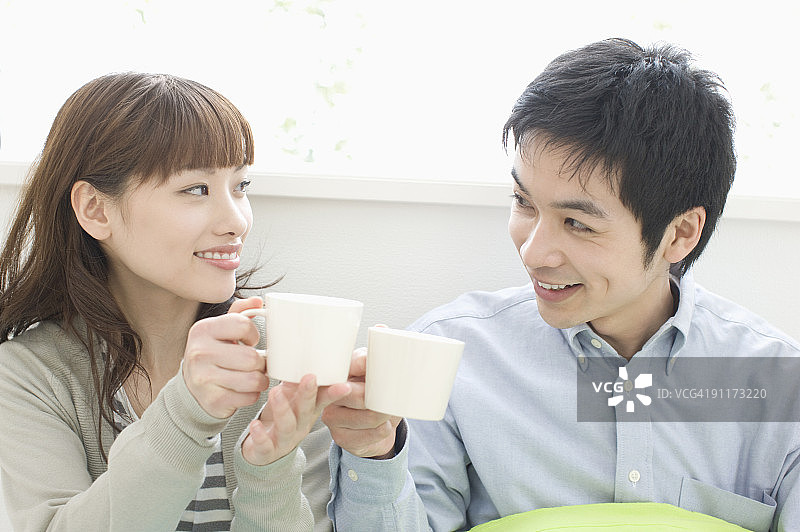 年轻情侣拿着马克杯图片素材