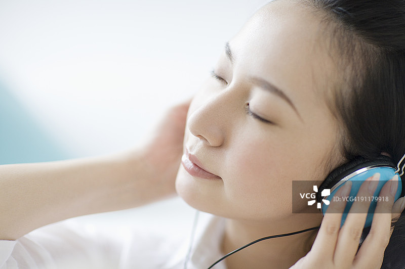 闭着眼睛用耳机听音乐的女人图片素材
