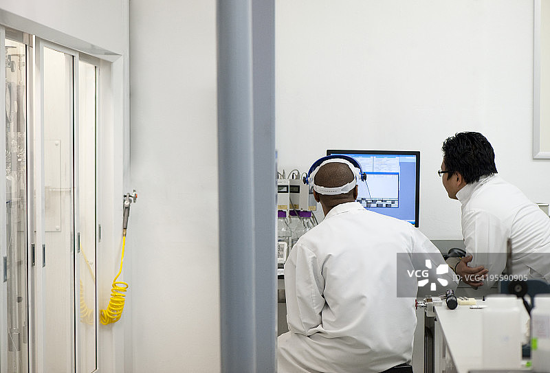 两名实验室工作人员在电脑旁讨论图片素材