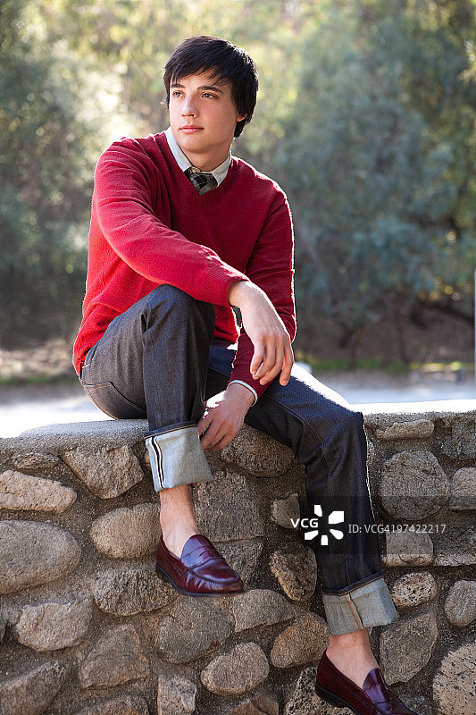 学生坐在石墙上图片素材
