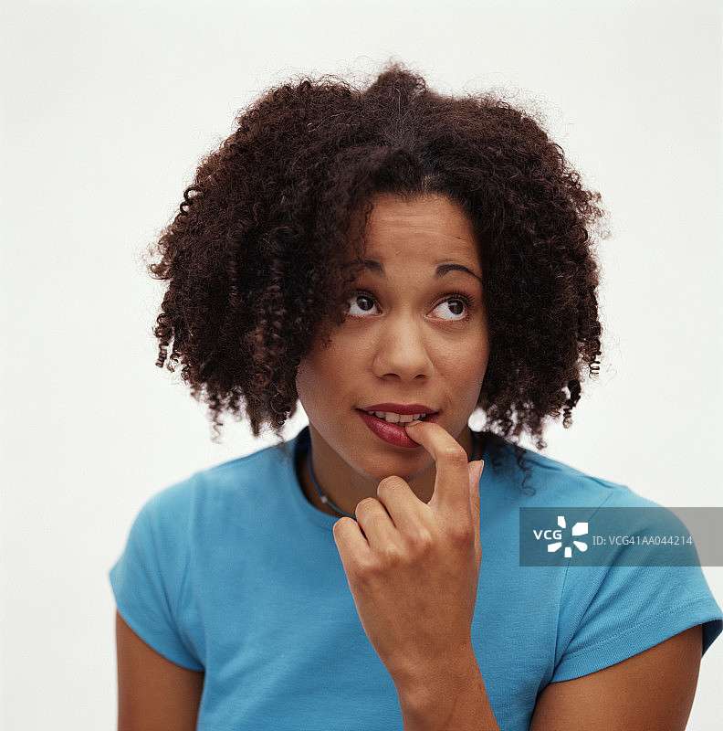 年轻女人在咬指甲图片素材