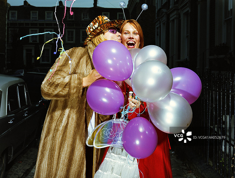 男人亲吻拿着气球的女人图片素材