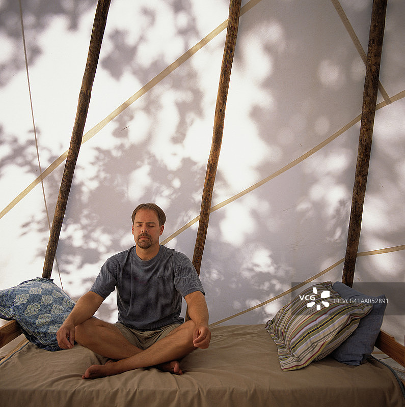 坐在床上冥想的男人图片素材