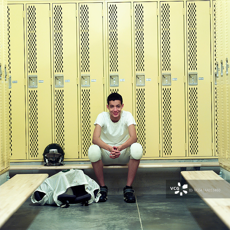 穿足球队服的青少年男孩在高中更衣室图片素材