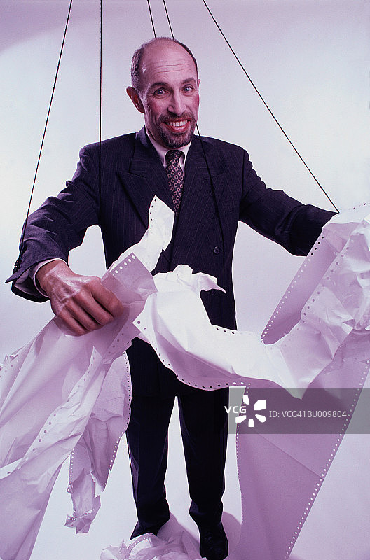 提线木偶商人撕碎电脑纸图片素材