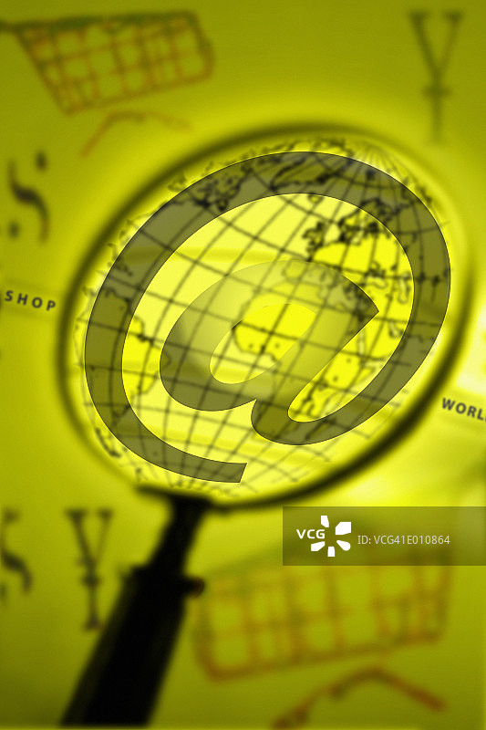 放大镜下的@符号与地球影像图片素材