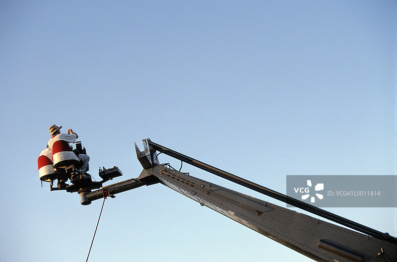 起重机上的摄影师和电影摄影机，后方，低角度视图图片素材