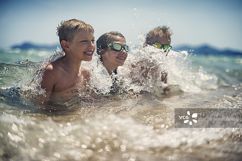 孩子们在海浪中玩耍图片素材