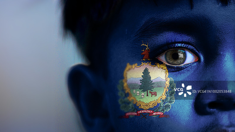 男孩的脸，看着镜头，面部裁剪图，脸上用数码方式放置了佛蒙特州州旗。图片素材