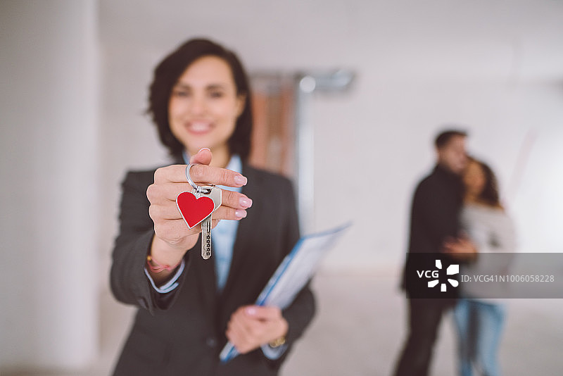 快乐的房地产经纪人刚刚将房产卖给年轻夫妇图片素材