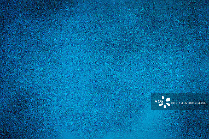 蓝色纹理背景与明亮中心聚光灯图片素材